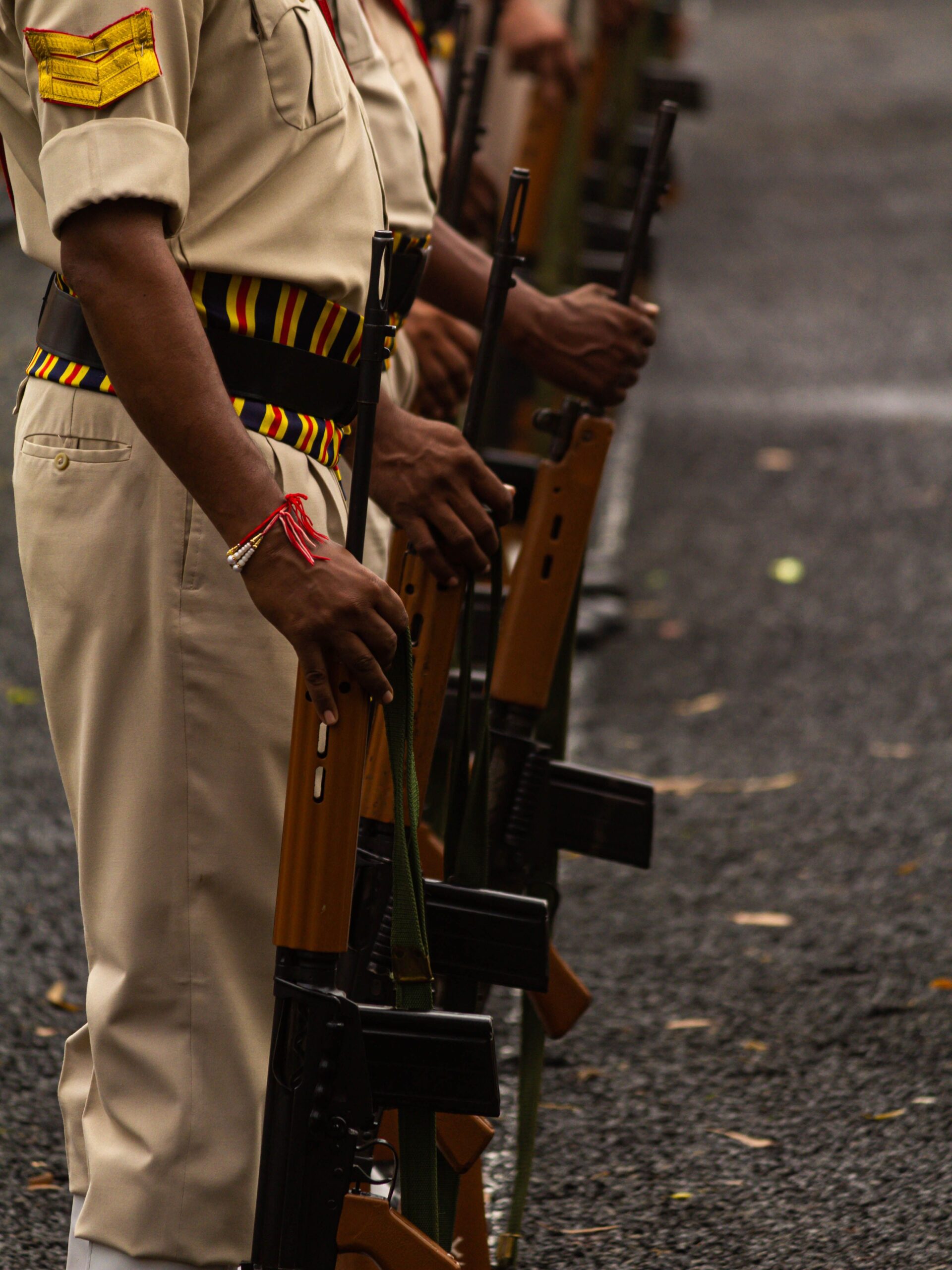 Close-up of Indian soldiers in uniform holding rifles, standing in formation.